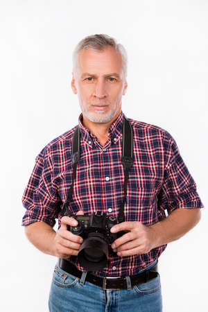 Calm and confident photographer holding a camera