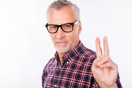 Gray aged man with glasses gesturing two fingers