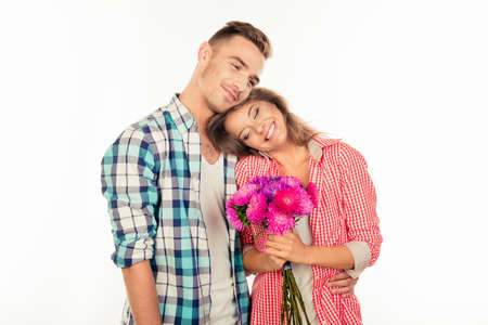 Handsome young man giving a bouquet to his cute belovedの写真素材