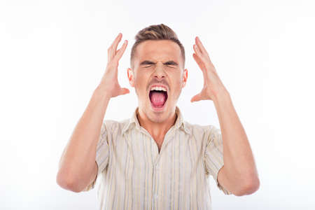 Portrait of a young furious man in striped shirt