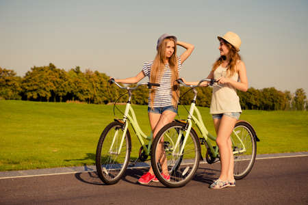 happy girls together to ride a bicycleの写真素材