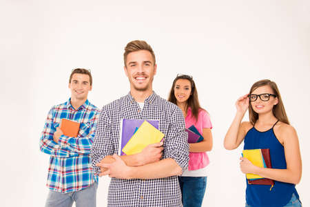 Cheerful group of students holding books and materials