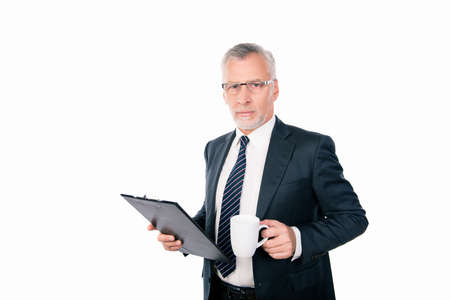 old confident businessman with glasses holding a folder and a cupの写真素材