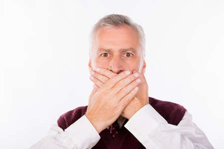 Handsome confident businessman with gray beard shutting mouthの写真素材