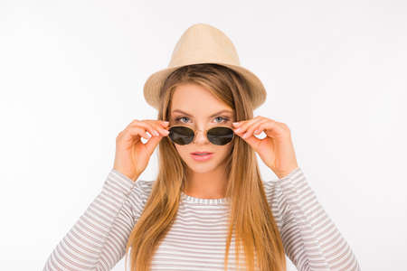 sexy girl with a hat putting glasses on her noseの写真素材