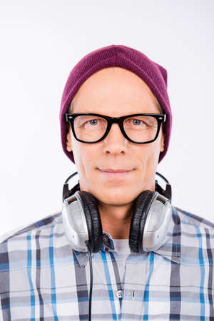 Handsome aged hipster in glasses with headphonesの写真素材