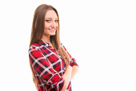 A side-view portrait of pretty young woman with crossed handsの写真素材