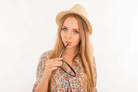 portrait young attractive women dreamy holding glassesの写真素材