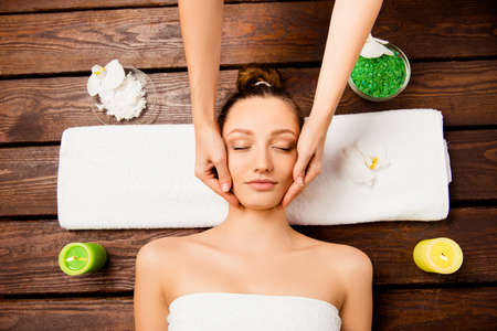 Top view of nice young woman laying in spa salon relaxing having spa proceduresの写真素材