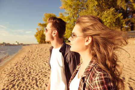 Couple in love  at the beach, side view photo