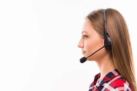 A close-up side-face portrait of a young agent of call centre