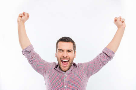 Happy young man screaming and showing fistsの写真素材