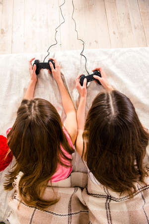 Top view photo of two girls playing video games