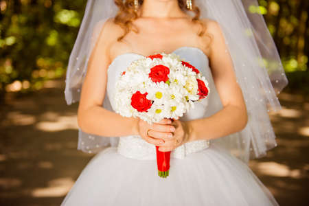 Beautiful bride holding a wedding bouquet