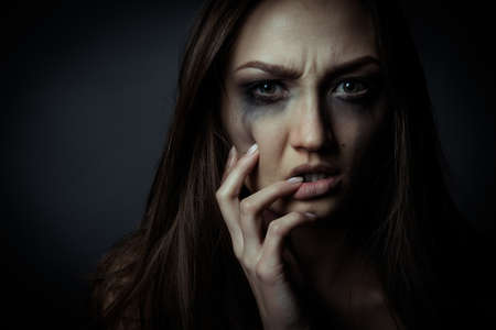 Close up photo of sorrow sad girl touching her faceの写真素材