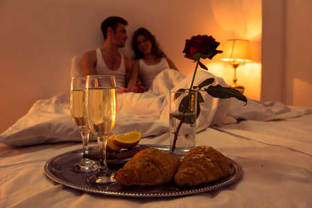 Couple in love having romantic supper in bedroomの写真素材