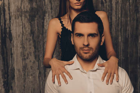 Close up photo of girl's hands lying on shoulders of her boyfriendの写真素材