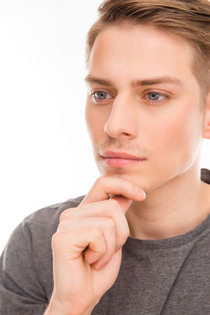 Close up photo of minded man touching his chin