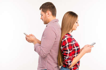 Couple in love loking in their phone and ignoring each other