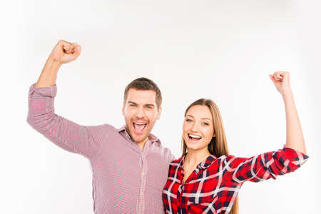 Smiling couple in love with raised handsの写真素材