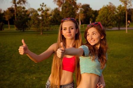 Happy girl thumbs up  in the parkの写真素材