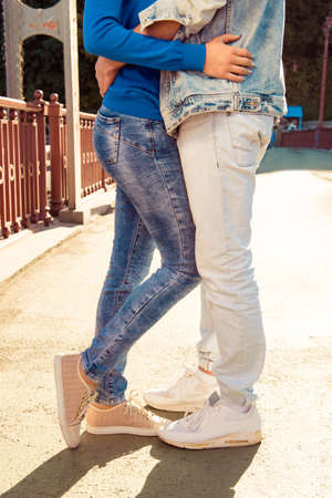 Cheerful couple in love on the bridge standing togetherの写真素材