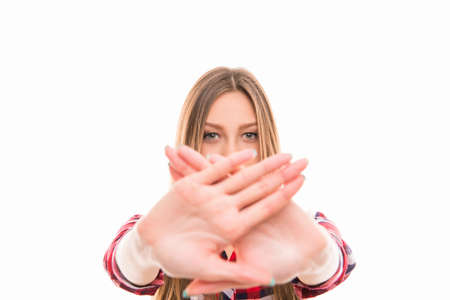 Close up photo of strict girl with prohibited gesture, focus on hands