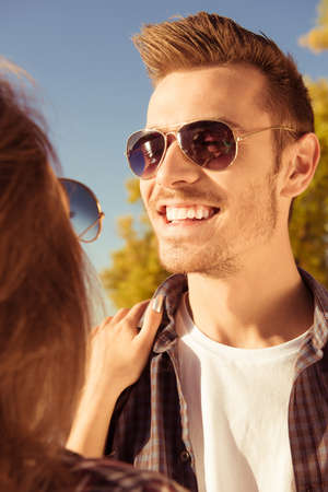 Couple in love, gir's hands on boy's shoulders, close-up photoの写真素材