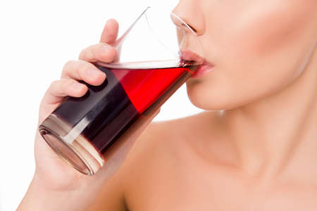 Close up photo of sensitive  woman drinking cherry juiceの写真素材