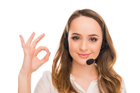 Cheerful young  agent of call centre gesturing OK