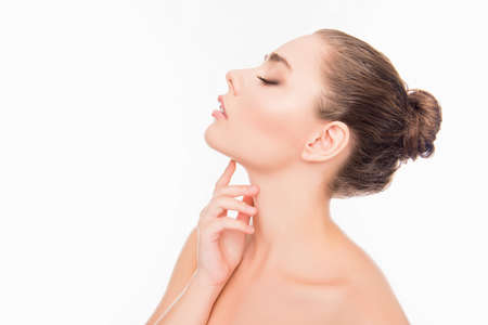 Side view photo of  woman with closed eyes touching her neck