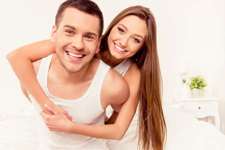 Close up portrait of smiling man piggybacking his girlfriend