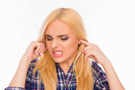 Young pretty woman covering her ears ignoring noise