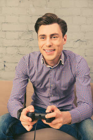 Portrait of cheerful happy man playing video games