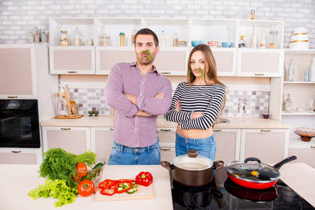 Comic and  couple in love holding dill like a moustacheの写真素材