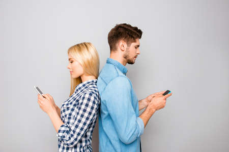 Couple in love ignoring each other with telephones