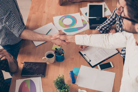 at conference  young  businesspeople shake hands to each other, top-view photoの写真素材