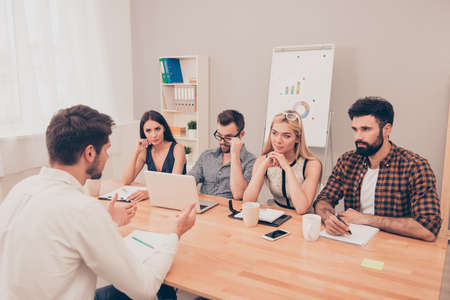 the young man is interviewed in order to get a job