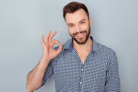 Cheerful young successful man showing "OK" gestureの写真素材