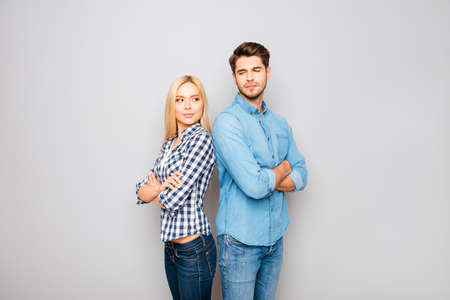 Young angry couple in love standing back to backの写真素材