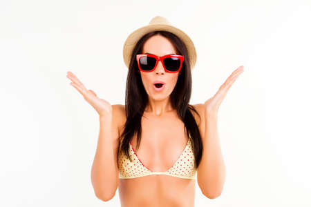 Wow! Pretty shocked woman in swimsuit, summer hat and glassesの写真素材