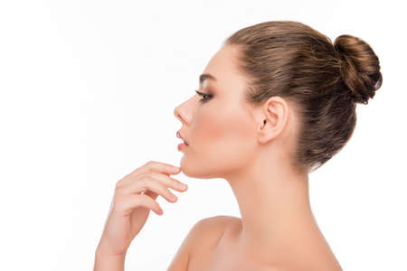 Side view of pretty woman touching chin on white background
