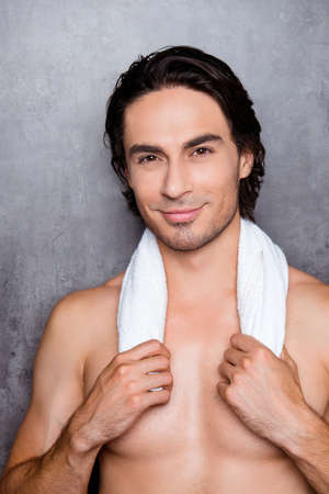 portrait  of sexy young smiling man holding  white towel  on his neck