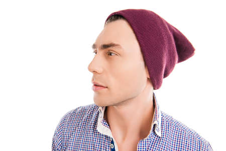 Handsome young man in violet cap, side face photoの写真素材