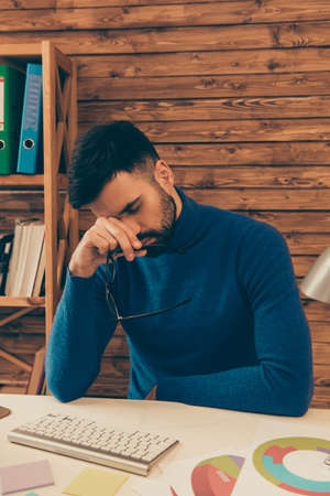Serious minded man thinking about way to solve his problemsの写真素材