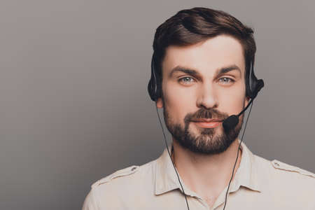 Portrait of handsome smiling man in head-phones in call centerの写真素材