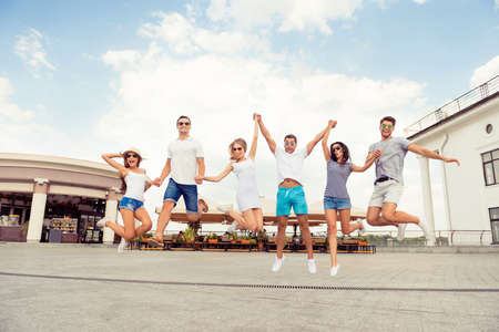 joyful success six friends having fun, achieving goal  and  jumpingの写真素材