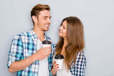 happy young couple in love drinking coffee and looking each otherの写真素材