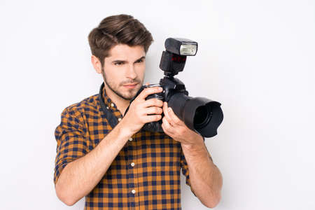 Portrait of professional photographer with digital camera taking photosの写真素材