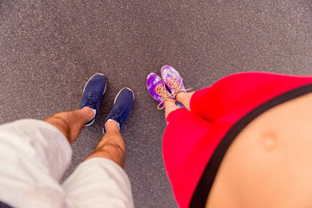 Top view photo of man and woman legs in sneakers after trainingの写真素材
